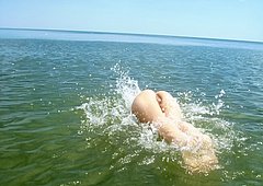 Watch her bathe her amazing teen body in the water